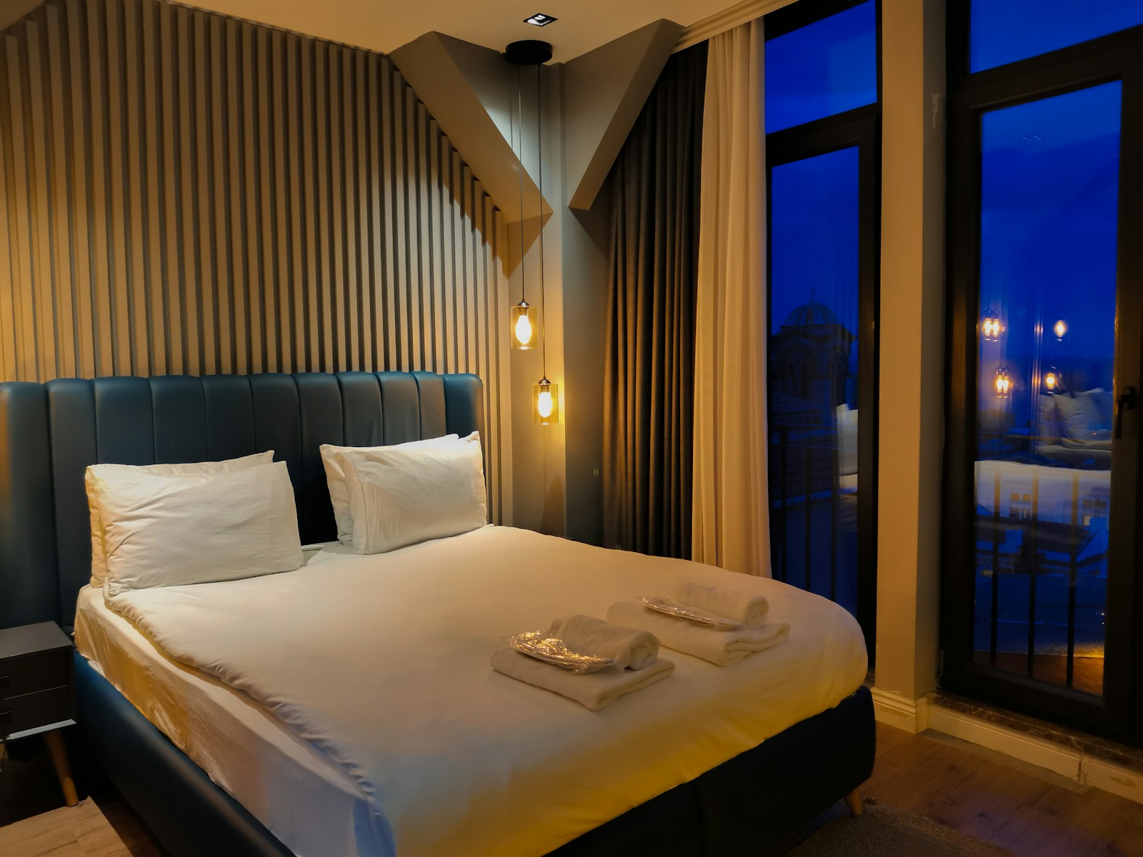 A bedroom with a large bed and a large window